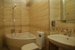 a bathroom with a tub and a toilet and a sink at Apartment.md in Chişinău +87 photos