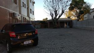 a black car parked in a brick parking lot at Santa Clara Hotel e Restaurante in Sao Pedro do Sul