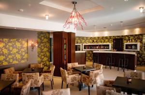 a restaurant with tables and chairs and a bar at Nicolas Hotel in Georgioupolis
