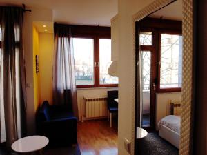 a room with a bedroom with a bed and windows at 2G Apartments in Zagreb