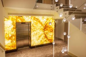 a hallway with a yellow wall in a building at Hotel Golf Prague in Prague