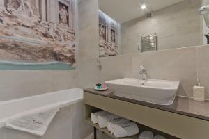 a white bathroom with a sink and a bath tub at Apartamenty Gdańsk EU - Sopot Apartamenty in Sopot
