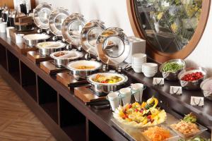 una línea de buffet con muchos platos de comida en Hiyori Hotel Maihama, en Urayasu