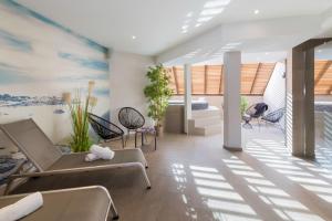 a living room with couches and chairs at Best Western Les Bains Hotel et SPA in Perros-Guirec