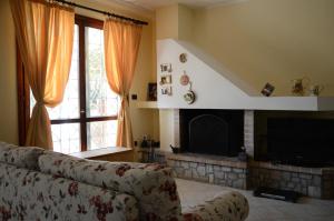 a living room with a couch and a fireplace at Casa De Luca in Arnesano