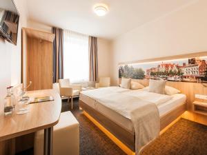 Postel nebo postele na pokoji v ubytování Hotel Jensen