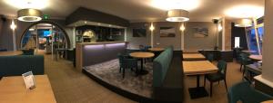 a restaurant with tables and chairs in a room at Hôtel des Rochers in Perros-Guirec