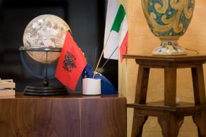 a desk with a globe and flags on it at Valle Himara in Piana degli Albanesi
