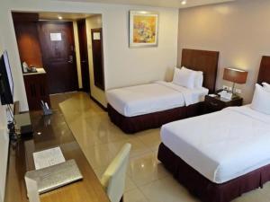 Postel nebo postele na pokoji v ubytování Mandarin Plaza Hotel