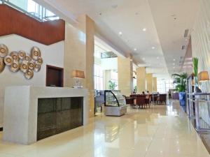 a lobby with a fireplace in the middle of a building at Mandarin Plaza Hotel in Cebu City