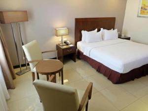 Postel nebo postele na pokoji v ubytování Mandarin Plaza Hotel