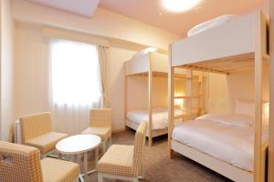 Postel nebo postele na pokoji v ubytování Hiyori Hotel Maihama