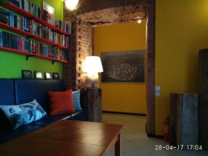 a living room with a couch and bookshelves at Vitamin Rooms in Saint Petersburg