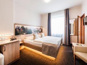 Postel nebo postele na pokoji v ubytování Hotel Jensen