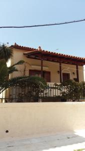 a house with a fence in front of it at Nineta's House Sea View near the Airport in Artemida