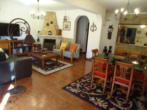 a living room with a couch and a table at Casa da Ribeira (Sesimbra) in Sesimbra