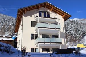a apartment building with snow on the ground at Haus Bichali in Sankt Anton am Arlberg