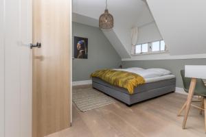 Postel nebo postele na pokoji v ubytování De Herberg Appartementen