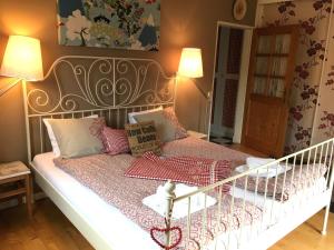 a small bedroom with a bed with a white crib at Landhaus Fay B&B in Bad Ischl