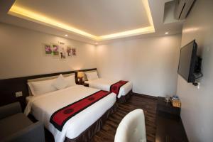 Postel nebo postele na pokoji v ubytování Sapa Wings Hotel