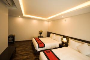 Postel nebo postele na pokoji v ubytování Sapa Wings Hotel