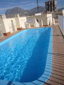 a large blue swimming pool on top of a building at Gemelos 11 - Fincas Arena in Benidorm