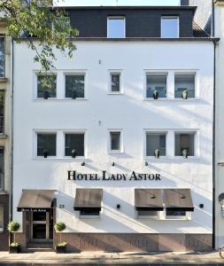 a white building with a hotel lady agent sign on it at Boutique Hotel Sir & Lady Astor - The Charming City Hotels in Düsseldorf