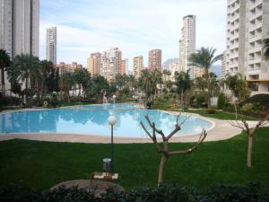 a large swimming pool in a city with tall buildings at Gemelos 22 - Fincas Arena in Benidorm