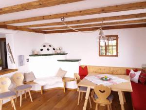 a living room with a table and chairs at Apart- Chalet GletscherGlück in Telfes im Stubai