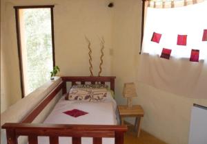 a bedroom with a bed and a window at Piedramora Tilcara in Tilcara