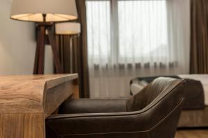 a living room with a chair and a table at Wyndham Stuttgart Airport Messe in Stuttgart