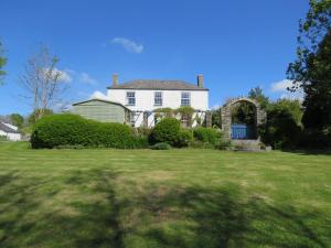 a large white house with a green yard at Kilna BnB in Saltash