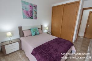 Postel nebo postele na pokoji v ubytování São Pedro Apartamentos