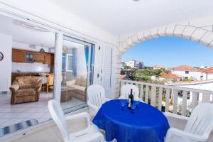 a room with a table and chairs on a balcony at Villa Snježana in Trogir