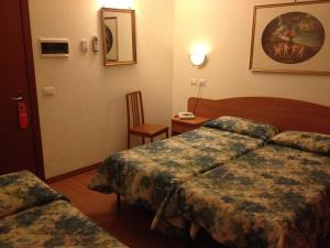 Postel nebo postele na pokoji v ubytování Hotel Tirreno