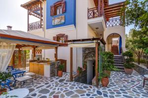 a house with a patio with a table and chairs at Niriides in Ammouliani