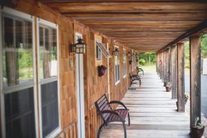 a covered walkway with benches on a building at Aerie Inn of Vermont in East Dorset +17 photos