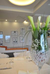 a vase with flowers in it sitting on a table at Hotel Villa Fiorita in Sorrento