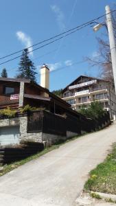 an empty street in front of a building at Snow Residence Azuga in Azuga