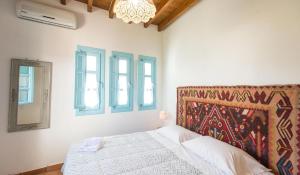 A bed or beds in a room at Villa Patmos Netia