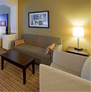 a living room with a couch and a coffee table at Holiday Inn Express Hotel & Suites Dallas West, an IHG Hotel in Dallas