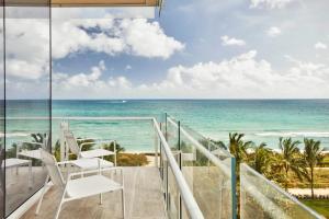 a balcony with a view of the ocean at Four Seasons Hotel at The Surf Club in Miami Beach