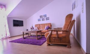 a living room with a couch and a table and a chair at Apartments&Room Babic in Kaštela