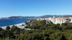 a view of a beach with trees and buildings at Savonaamare in Savona