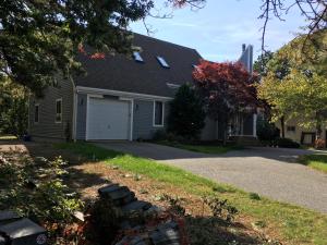 a house with a garage and a driveway at Contemporary & Spacious South Cape Beach House in Mashpee