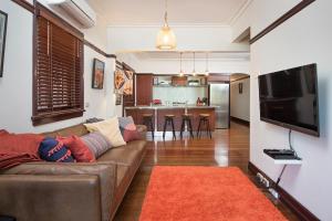 a living room with a couch and a kitchen at Anville Court in Brisbane