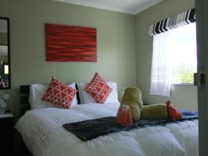 a bedroom with a bed with a stuffed animal on it at Kepler Mountain View in Manapouri