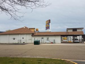 a gas station with a sign in front of it at Budget Host Melody Lane in Raton