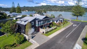 an aerial view of a house next to the water at Tides Reach Whitianga in Whitianga