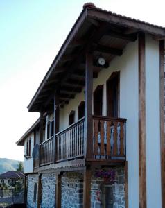 a house with a balcony on top of it at Semana Guesthouse in Vrata